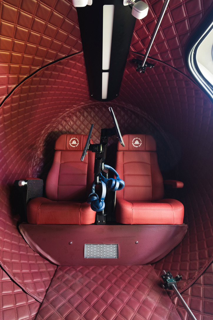 Interior of the hyperbaric chamber with two reclining seats and audio headsets
